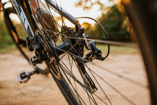 istock Man feet on bicycle pedal under sunlight on the road 1280572025
