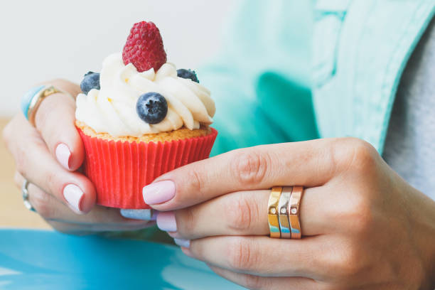 istock Woman with a cupcake in the hands 1280572811
