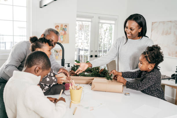 istock Three generation family wrapping Christmas presents together 1280573436
