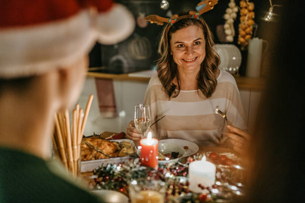 istock Family enjoying Christmas dinner at dining table 1280573757