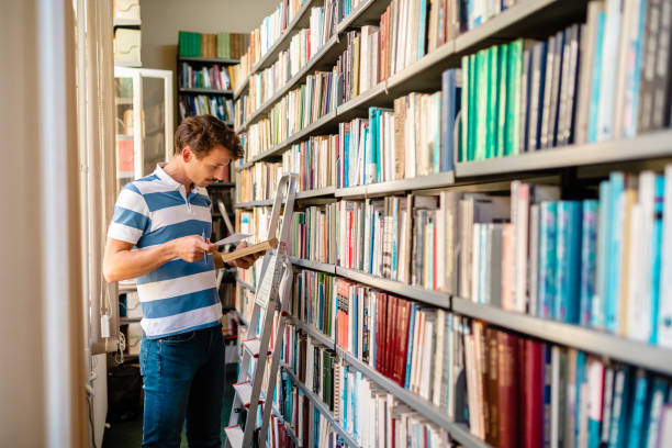 istock University student checking that he got a right author of textbook he need to prepare an exam 1280573795