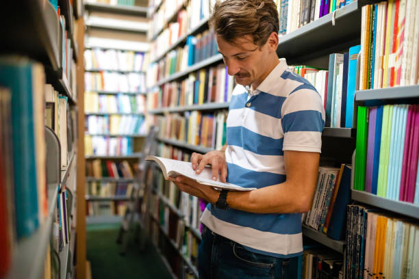 istock This book really interested him, he just can't put a look away from the book 1280573965