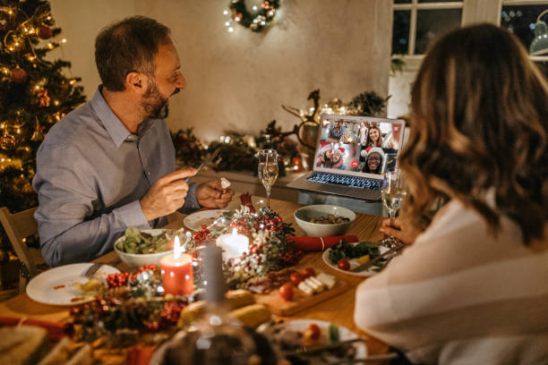 istock Couple online chatting with friends having Christmas dinner 1280576137