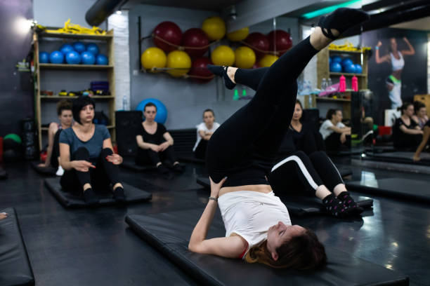 istock A female Pilates teacher showing her students a new exercise 1280581728