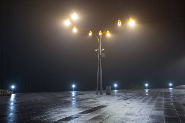 istock lantern stay on a town square in a mist, night city scene 1280581830