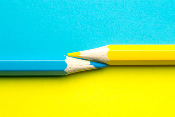 istock Yellow and blue pencil on blue-yellow background 1280588855