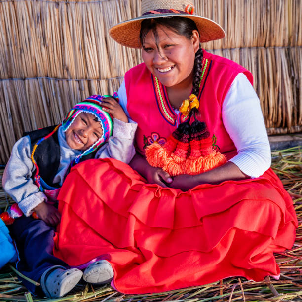 istock Mother and her son on Uros floating island, Lake Tititcaca, Peru 1280589628