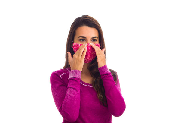 Beautiful young woman portrait wearing a mask on a white background.