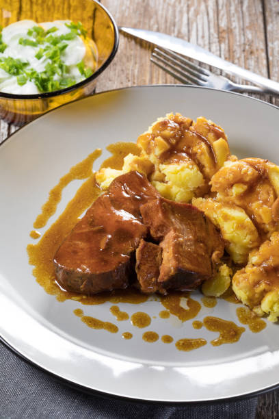 istock Braised pork neck in own sauce served with boiled potatoes. 1280592308