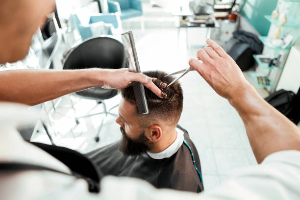 istock Hairdresser working with scissors and comb 1280592679