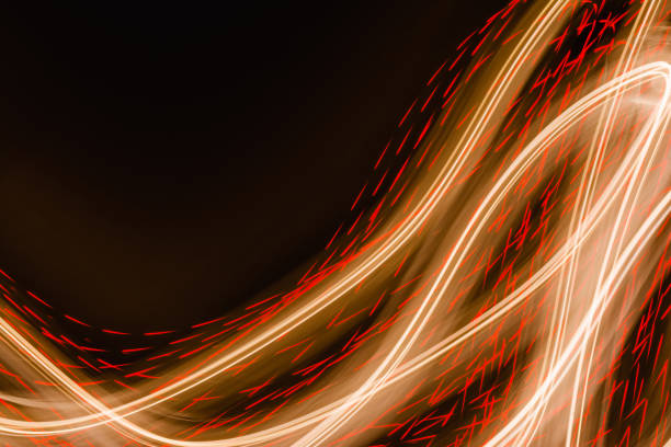 istock Yellow orange light effects, straight and curved lines on dark backdrop. Abstraction neon light lines background 1280594819
