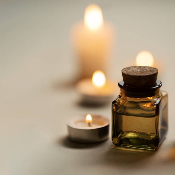 istock Tranquil and concise spa composition with oil flask and candles. Copy space 1280599903