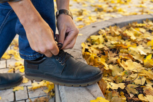 istock man tying shoelace in autumn park 1280600300