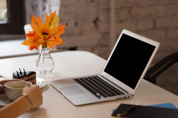 istock laptop and a cup of tea on the table, informal workplace 1280601777