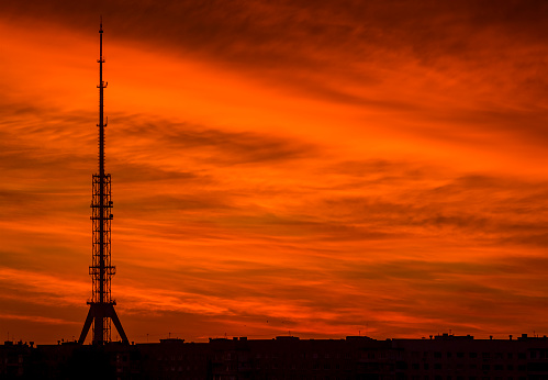 Silhouette of Telecommunications Tower on background of beautiful red sunset or sunrise sky. Kharkiv Television Tower, Ukraine.