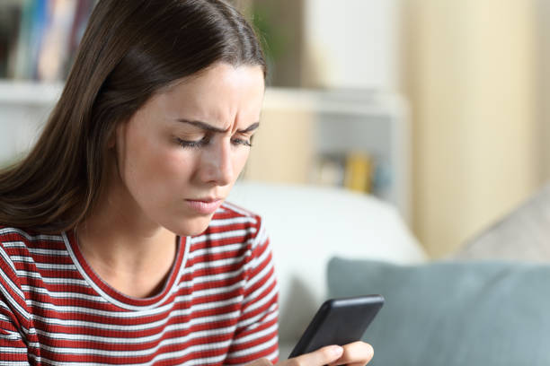 istock Annoyed woman checking smart phone at home 1280611033