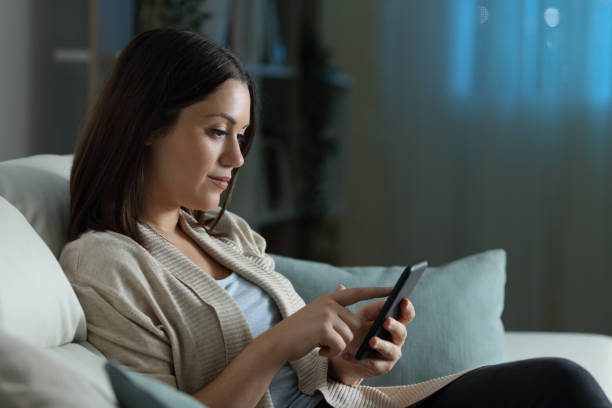 istock Woman using smart phone in the night at home 1280611403