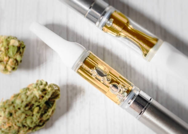 cannabis vape pen with cannabis flower THC:CBD cannabidiol vape pens with medical marijuana. cartridge stock pictures, royalty-free photos & images