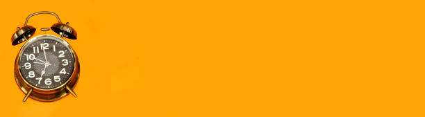 istock alarm o'clock showing 7 o'clock isolated on orange background 1280616126
