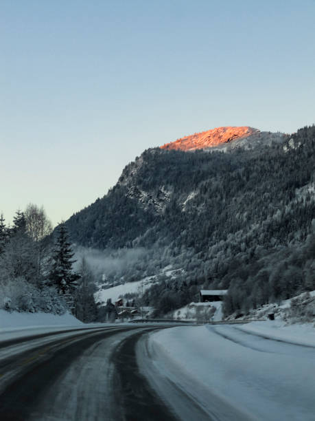 istock Driving at sunrise through mountains and forests in Norway. 1280618941