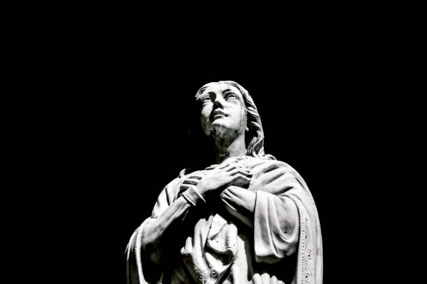 istock Black and white Angel, old statue ofpraying angle, black background with copy space 1280622134
