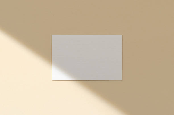istock Business card mockup on a beige background with shadow overlay. 85x55 mm. 1280622955