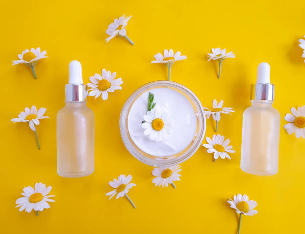 istock cosmetic cream, flower on a colored background 1280627992