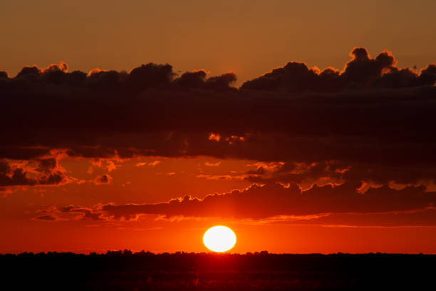 istock Beautiful sunset with clouds above the agricultural field 1280629309