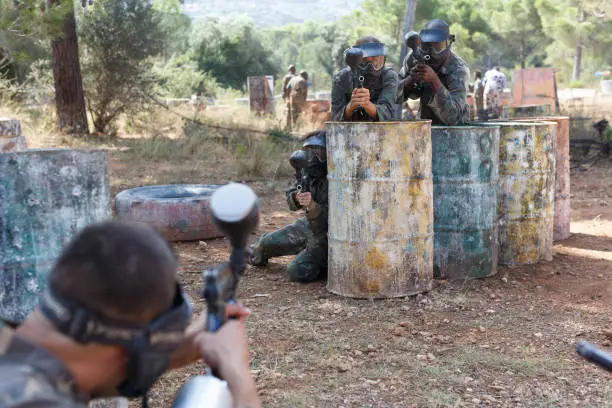 Photo of Paintball players in shootout outdoors