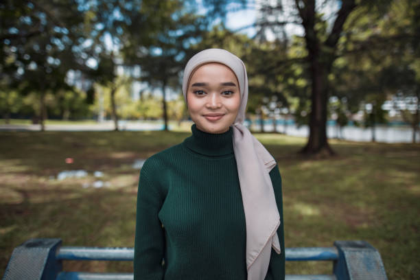 Asian women enjoy nature. She is smiling and looking at camera.