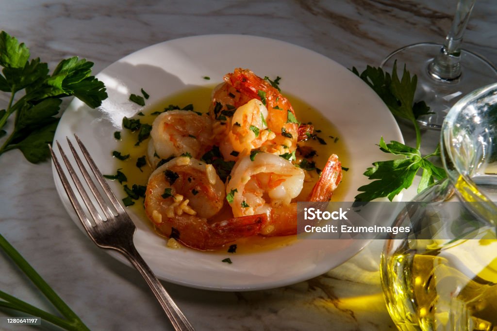 Portuguese Garlic Shrimp Portuguese dinner camarao ao alho e oleo garlic shrimp with dramatic sunlight Saute Stock Photo