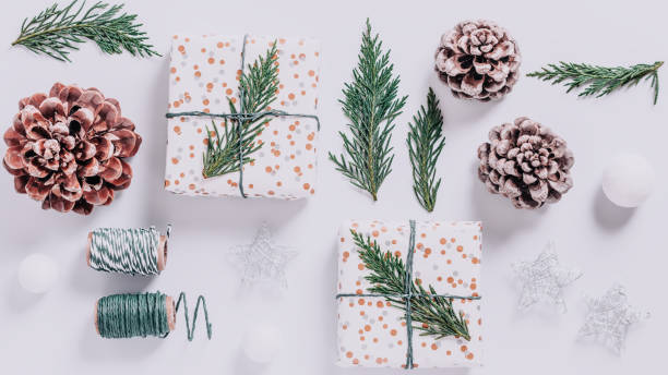 istock Wrapped presents with cedar and cones on white background. Preparation for Christmas holiday concept, christmas border, copy space, square format 1280643935