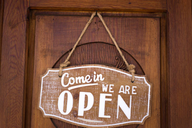 istock Open Sign Hanging on Brown Wood Door 1280644802