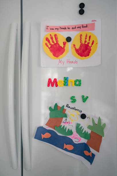 istock vertical image of art and magnets on fridge 1280653020