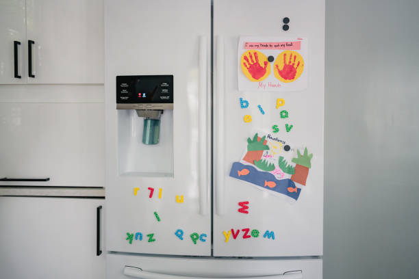 istock Child art and magnets on white fridge 1280653033