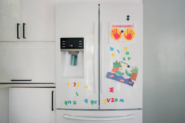 fridge with magnets and child artwork fridge with magnets and child artwork in Washington, DC, United States refrigerator photos stock pictures, royalty-free photos & images