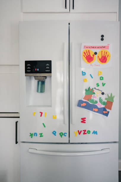 kitchen fridge with magnets and kid crafts kitchen fridge with magnets and kid crafts in Washington, DC, United States number magnet stock pictures, royalty-free photos & images