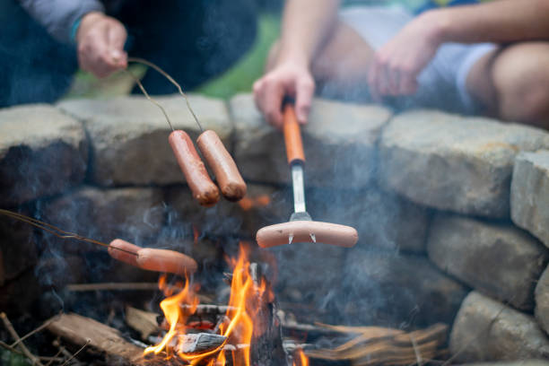 Hot dogs being roasted over a camp fire in San Diego, CA, United States