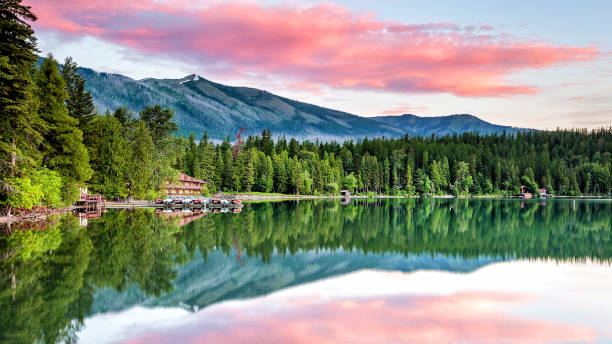 lake mcdonald with a vibrant colorful sunrise in glacier national park usa - montana mountain mcdonald lake us glacier national park imagens e fotografias de stock
