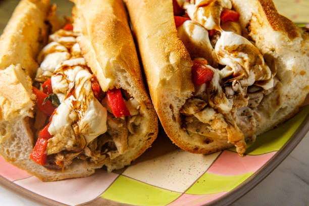 Grilled Chicken Mozzarella Sandwich Grilled chicken sandwich topped with melted mozzarella and balsamic vinaigrette dressing torpedo sandwich stock pictures, royalty-free photos & images
