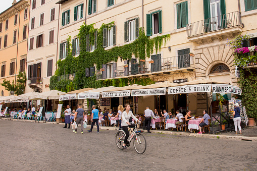 June 5, 2018 - Rome, Italy. Tourists in Rome, Italy walking and eating on the streets of Rome.