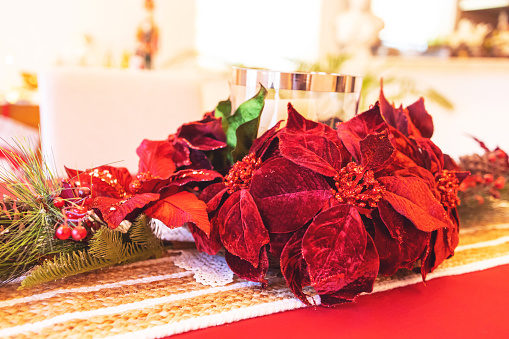 Several artificial poinsettia flower heads red glittery flowers with gold central stamens