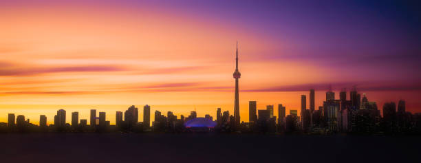 Toronto, Canada - View of the urban skyline from Polson Pier as sun sets behind city.
