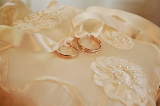istock beautiful gold wedding rings on the pillow 1280686417