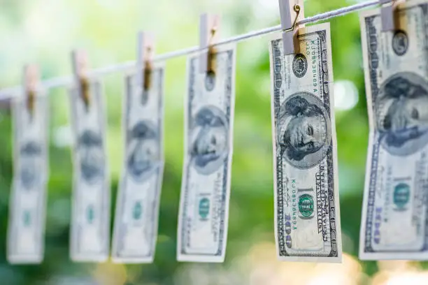 Money Laundering. Money Laundering US dollars hung out to dry. 100 dollar bills hanging on clotheslines