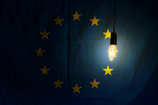 European Union flag lit by a lamp. background