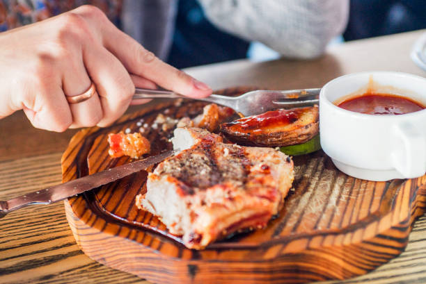 istock Woman eating steak in a restaurant 1280691042
