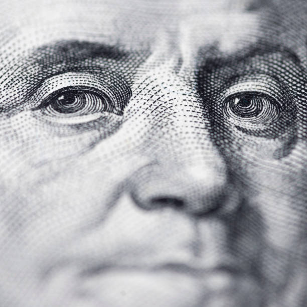istock Benjamin Franklin's look on a hundred dollar bill. Benjamin Franklin portrait macro usa dollar banknote or bill 1280691333