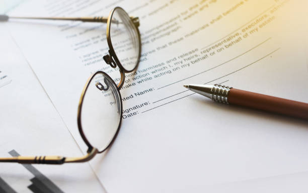 istock Agreement with pen and glasses. Selective focus. Business work office career concept 1280693143