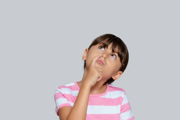 istock Cute little girl looking up, just have an idea, Copy space 1280698368